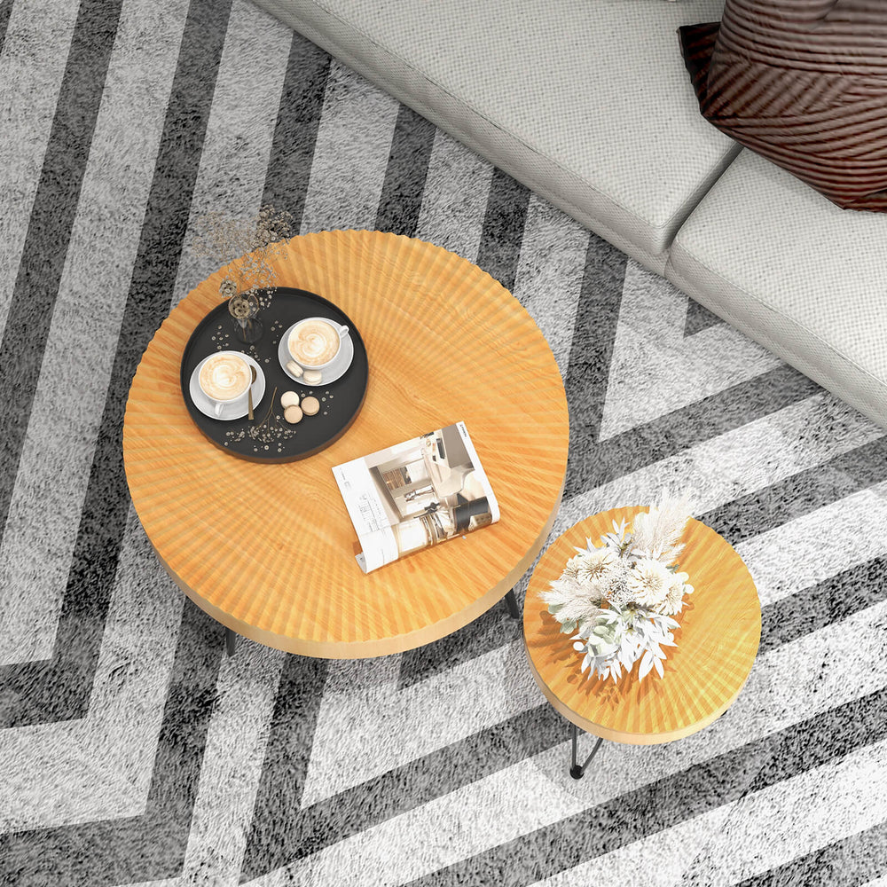 Round wooden coffee table set with metal legs, featuring a radial pattern, perfect for cups and magazines in any living.