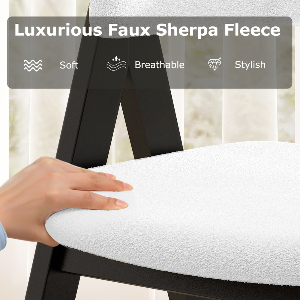 White faux sherpa upholstered dining chair with curved back and armrests, crafted from durable black rubber wood.