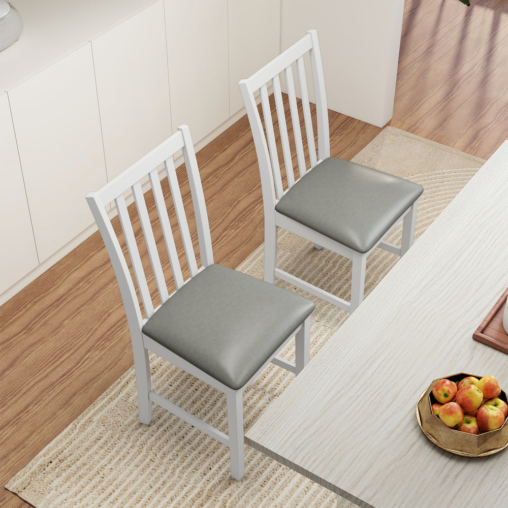 Two white wooden dining chairs with padded seats, crafted from rubber wood, ideal for dining rooms and cafes.