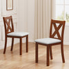 Two wooden dining chairs with padded beige seats and X-shaped backs, crafted from durable acacia wood for comfort and.