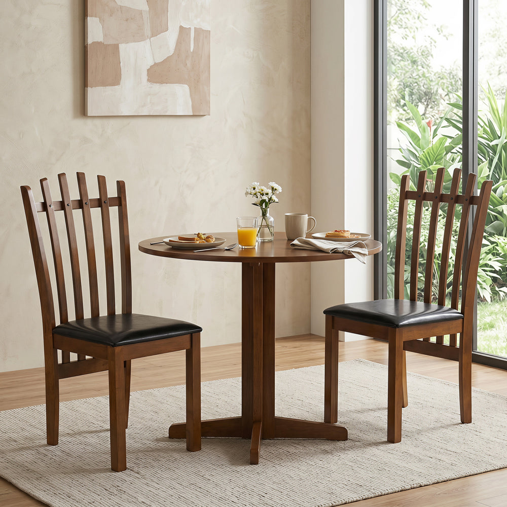 Two wooden dining chairs with spindle backs and black PU leather seats, perfect for stylish dining spaces.