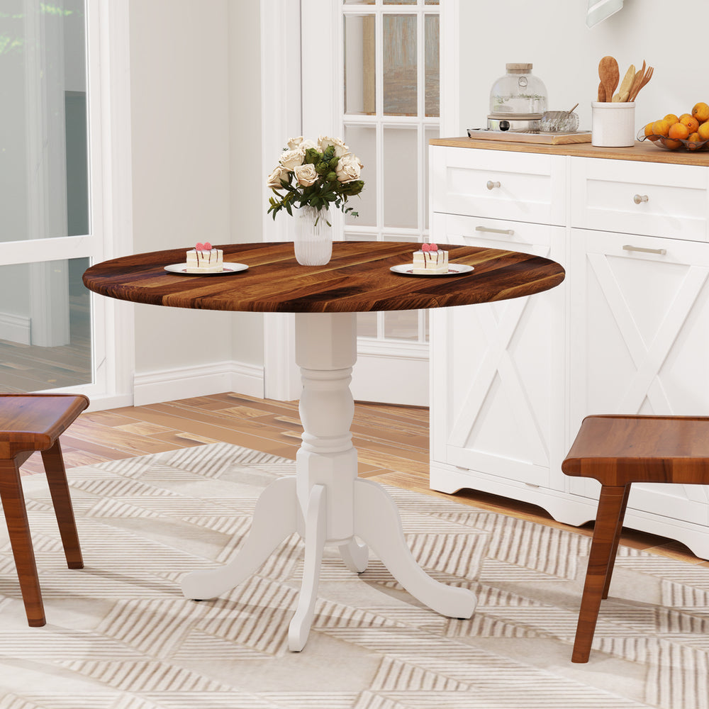 Round wooden dining table with walnut finish and white curved trestle legs, suitable for kitchen or dining room.