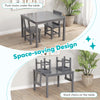 Gray wooden kids table with two chairs stacked on top, showcasing space-saving design and sturdy construction.