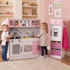Wooden kitchen playset in pink with lights and sounds, featuring a stove, refrigerator, and engaging accessories for kids.