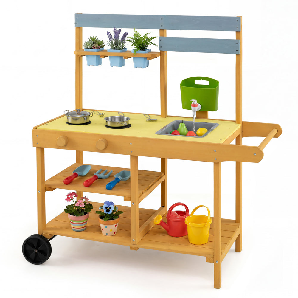 Wooden outdoor mud kitchen for kids in yellow with 2 stoves, sink, flowerpots, and wheels for mobile play.