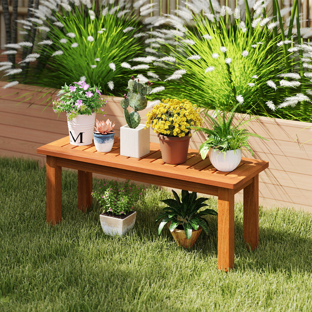 Wooden plant stand showcasing potted plants, crafted from solid wood with a brown finish, ideal for outdoor and indoor.