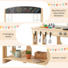 Wooden pretend play kitchen featuring a blackboard, decorative windows, 4 hanging hooks, and a bottom shelf for.