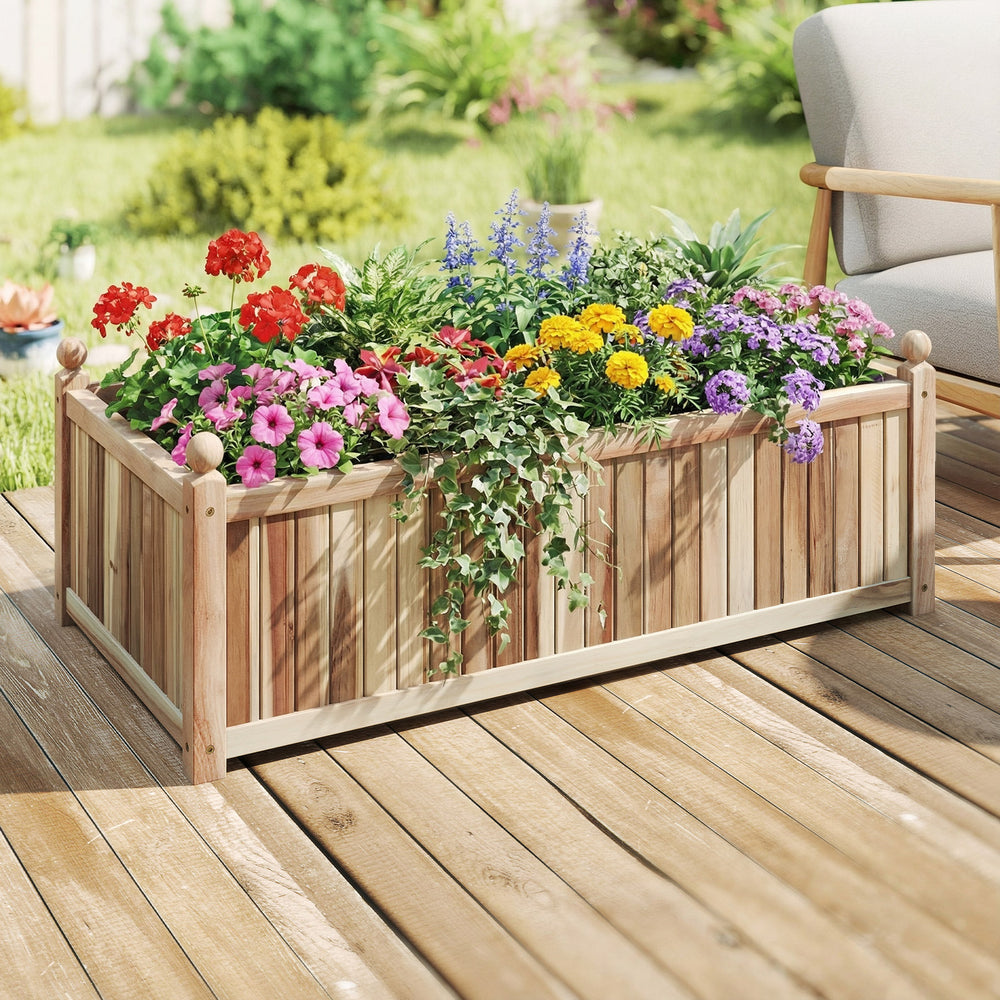 Wooden raised garden bed made of natural acacia wood, filled with colorful flowers, ideal for outdoor patios and.