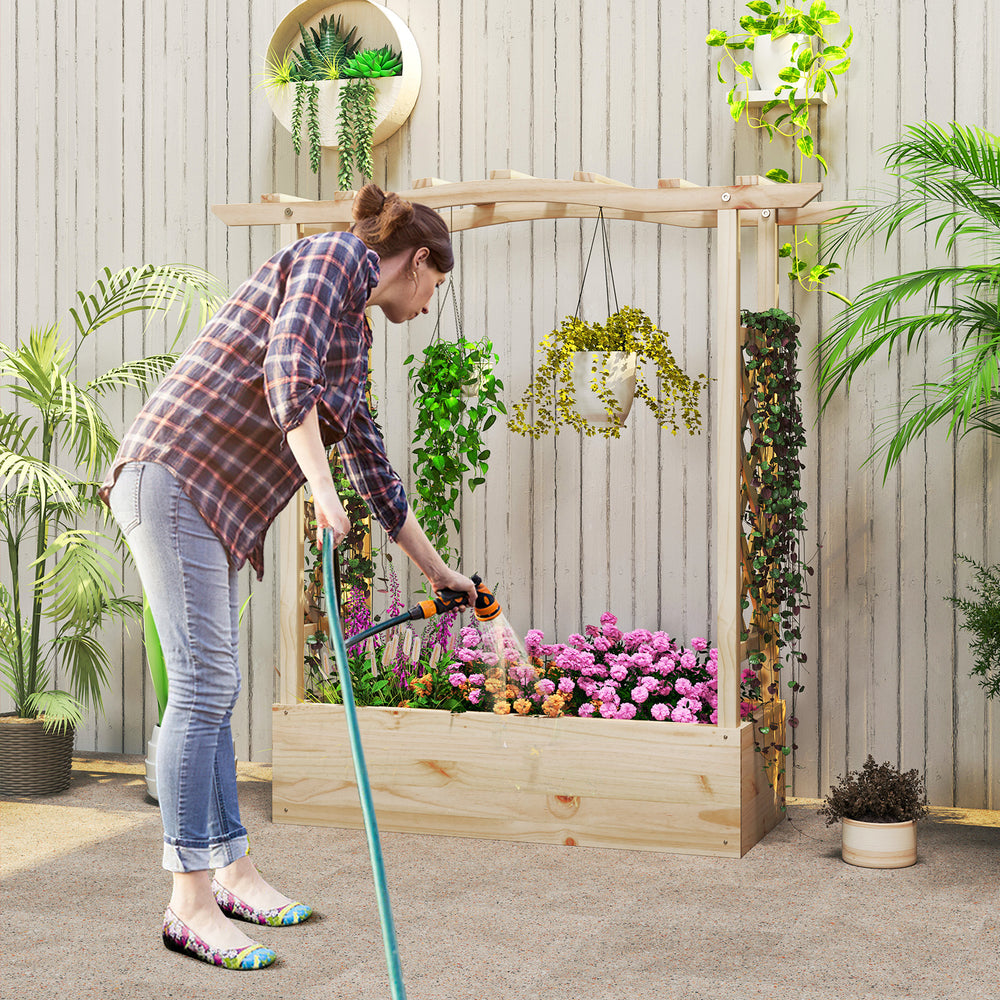 Wooden raised garden bed planter box with trellis, featuring a woman watering vibrant flowers for a stylish outdoor.