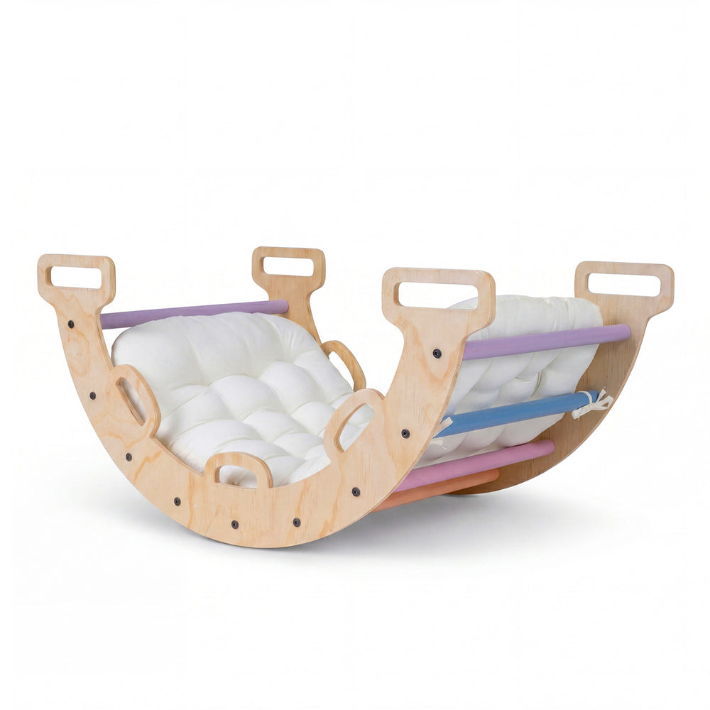 Wooden rocking climbing arch with multicolor cushion, designed for kids' play and development in a Montessori style.