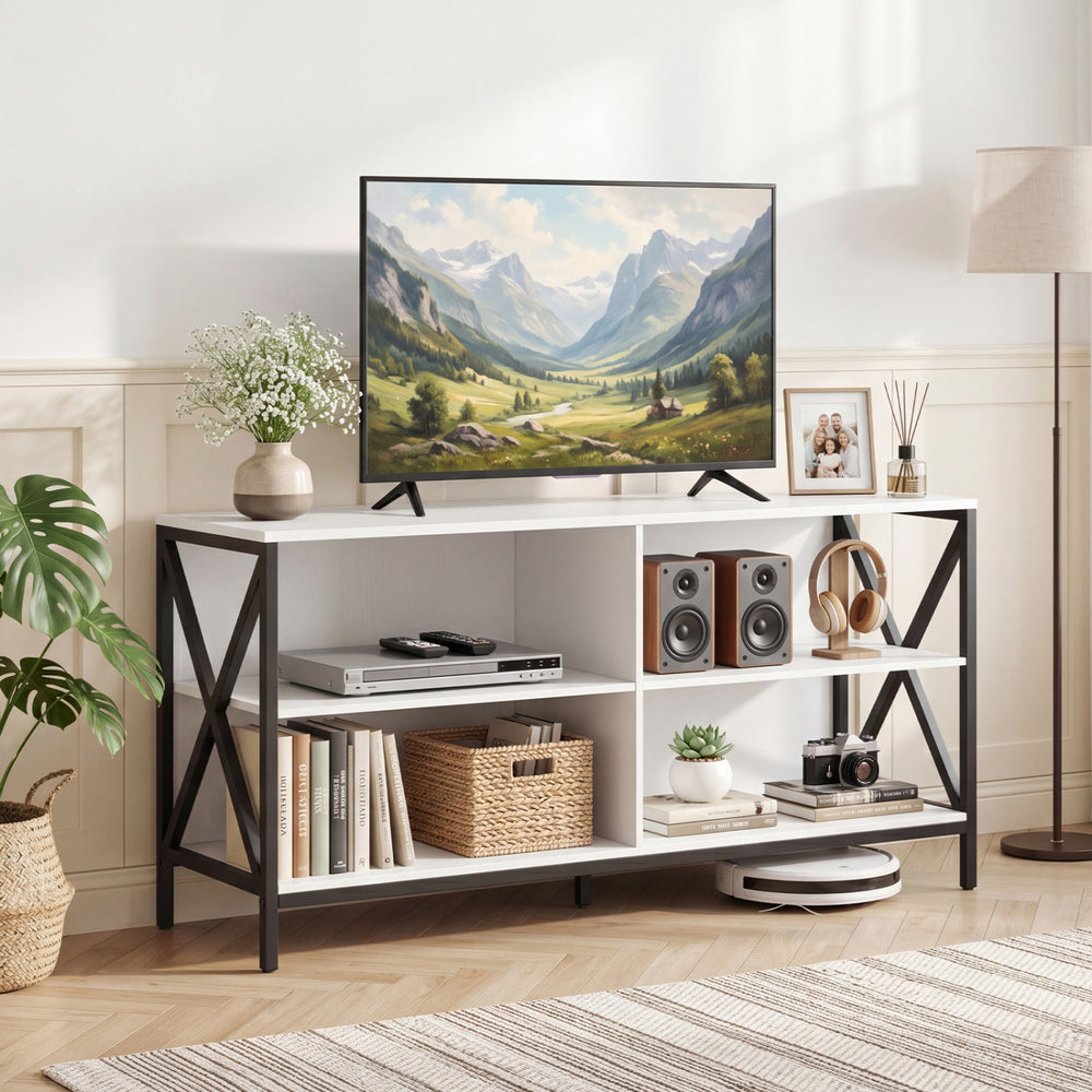 White wooden TV stand with X-shaped frame and large tabletop, providing open storage for books and audiovisual equipment.