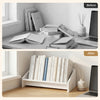 Wooden tilting bookcase in white, showcasing organized books and magazines for a tidy desktop environment.