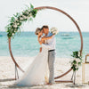 Wooden wedding arch made of natural fir wood, perfect for beach ceremonies and customizable with flowers and.