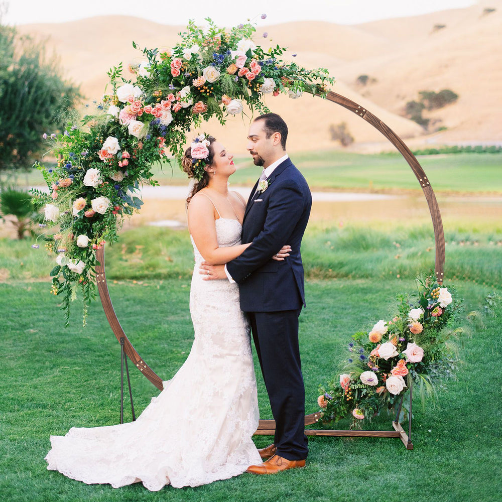 Wooden round wedding arch made of natural fir wood, ideal for outdoor ceremonies and floral decorations.