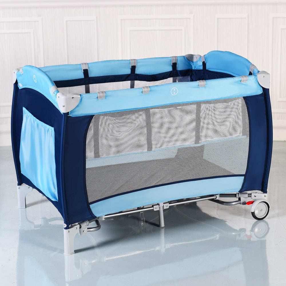 Foldable baby crib playpen in blue with mosquito net, storage, and detachable rocking legs for travel convenience.