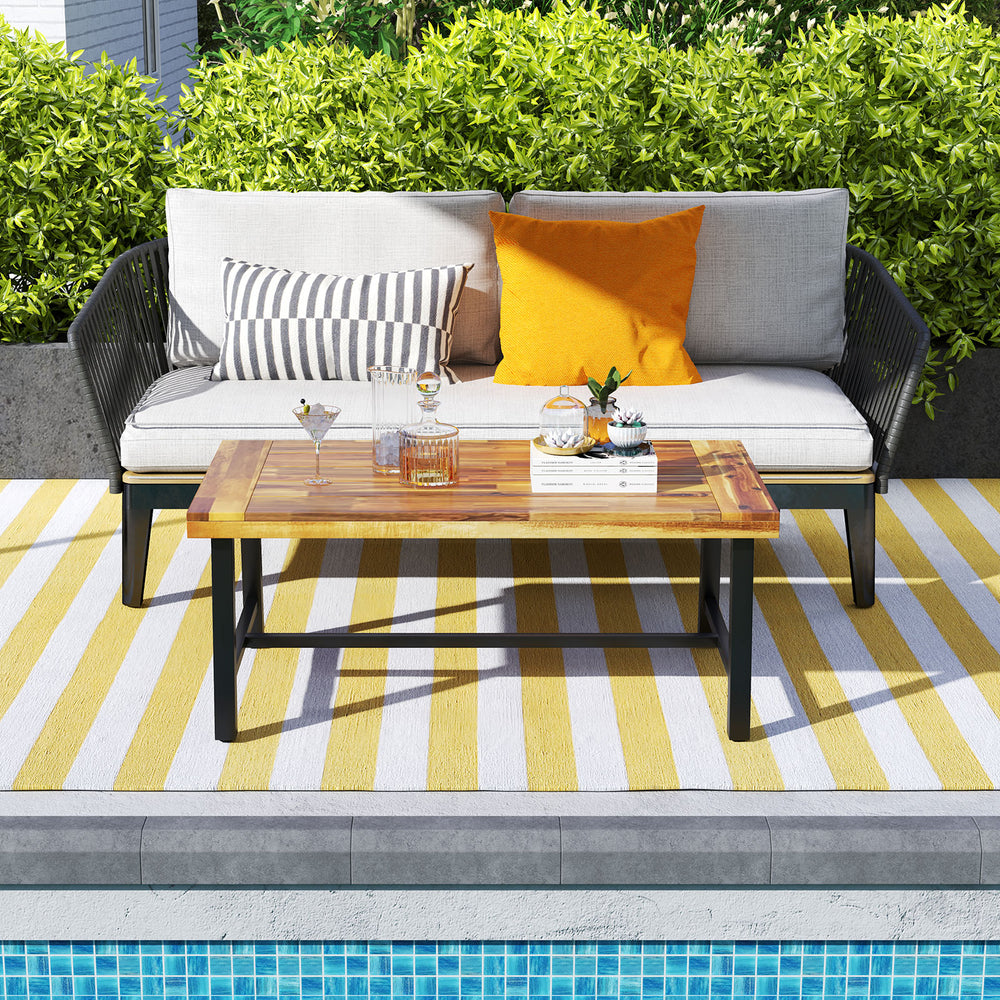 Acacia wood coffee table with thickened top and heavy-duty metal legs, perfect for outdoor lounging by the pool.