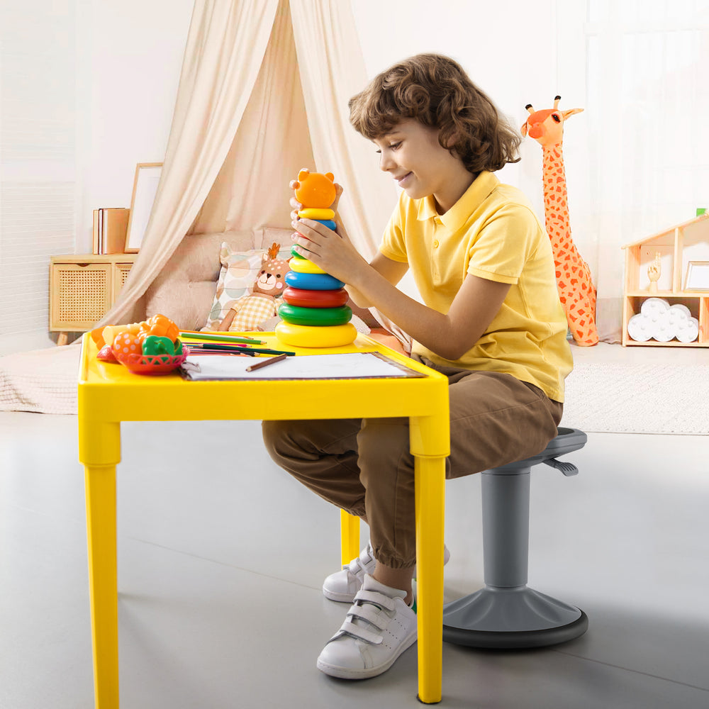 Adjustable-height gray wobble chair for active learning, designed for kids to improve posture and concentration.