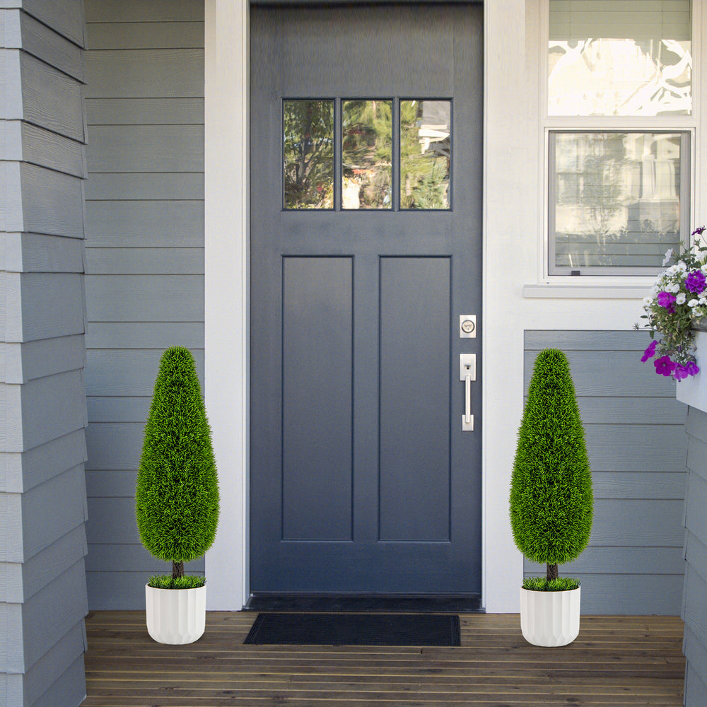 Teardrop-shaped artificial cedar bush in a white nursery pot, perfect for enhancing doorways or office spaces.