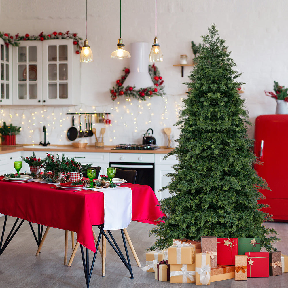 Green hinged artificial Christmas tree with 721 branch tips, set in a festive kitchen with holiday decorations and.