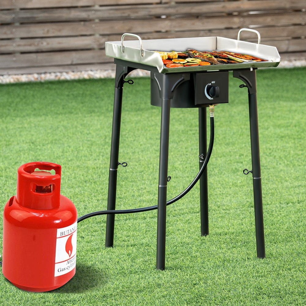 Portable propane camp stove with adjustable legs, sturdy cast iron design, 100000 BTU output for outdoor cooking.