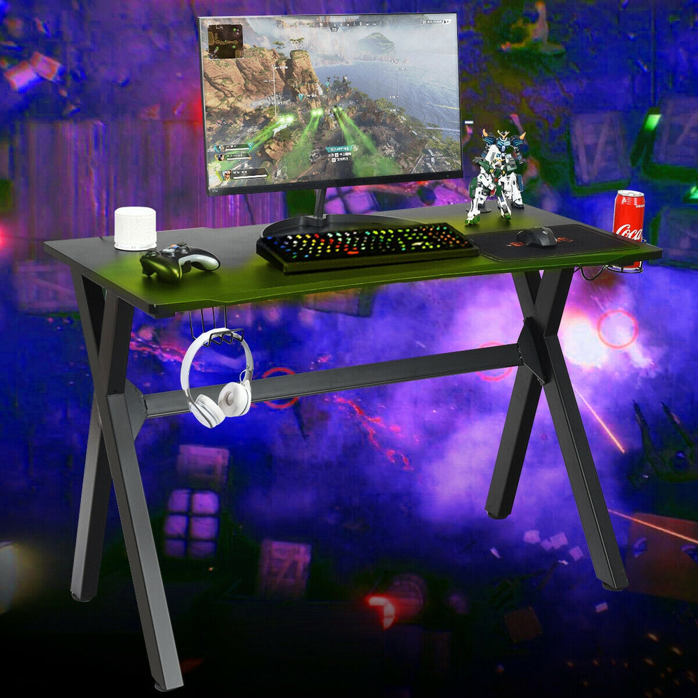 Ergonomic gaming desk with PVC carbon fiber surface, cup holder, headphone hook, and spacious tabletop for gaming setup.