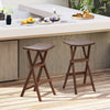 Set of 2 teak wood bar stools with saddle seats and footrests, perfect for kitchen islands and balconies.