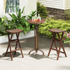 Two teak wood bar stools with saddle seats and footrests, perfect for kitchen islands or balconies.