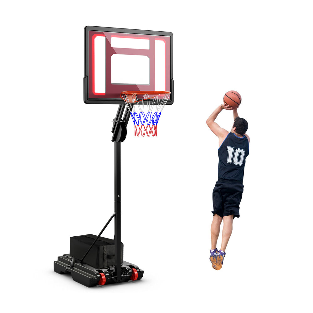 Player shooting a basketball at the adjustable height hoop, featuring a shatterproof backboard for safety and.