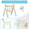 Portable wooden baby activity gym with teething toys, blue accents, and foldable design for easy storage.