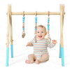 Wooden baby activity gym with hanging teething toys in blue, promoting physical and mental development for infants.