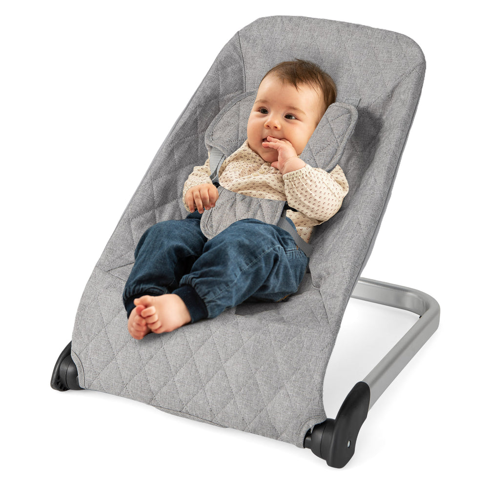 Light gray baby bouncer seat with a secure 5-point harness, ergonomic design, and sturdy aluminum frame for soothing.