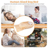 Fluffy brown human-sized dog bed with soft blanket and plump pillow, perfect for cozy naps and outdoor use.
