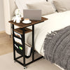 C-shaped end table with rustic wood grain, built-in charging station, and retractable tabletop for bedside convenience.