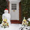 Pre-lit 2 feet flocked Christmas trees with red balls and warm LED lights, perfect for festive outdoor decoration.