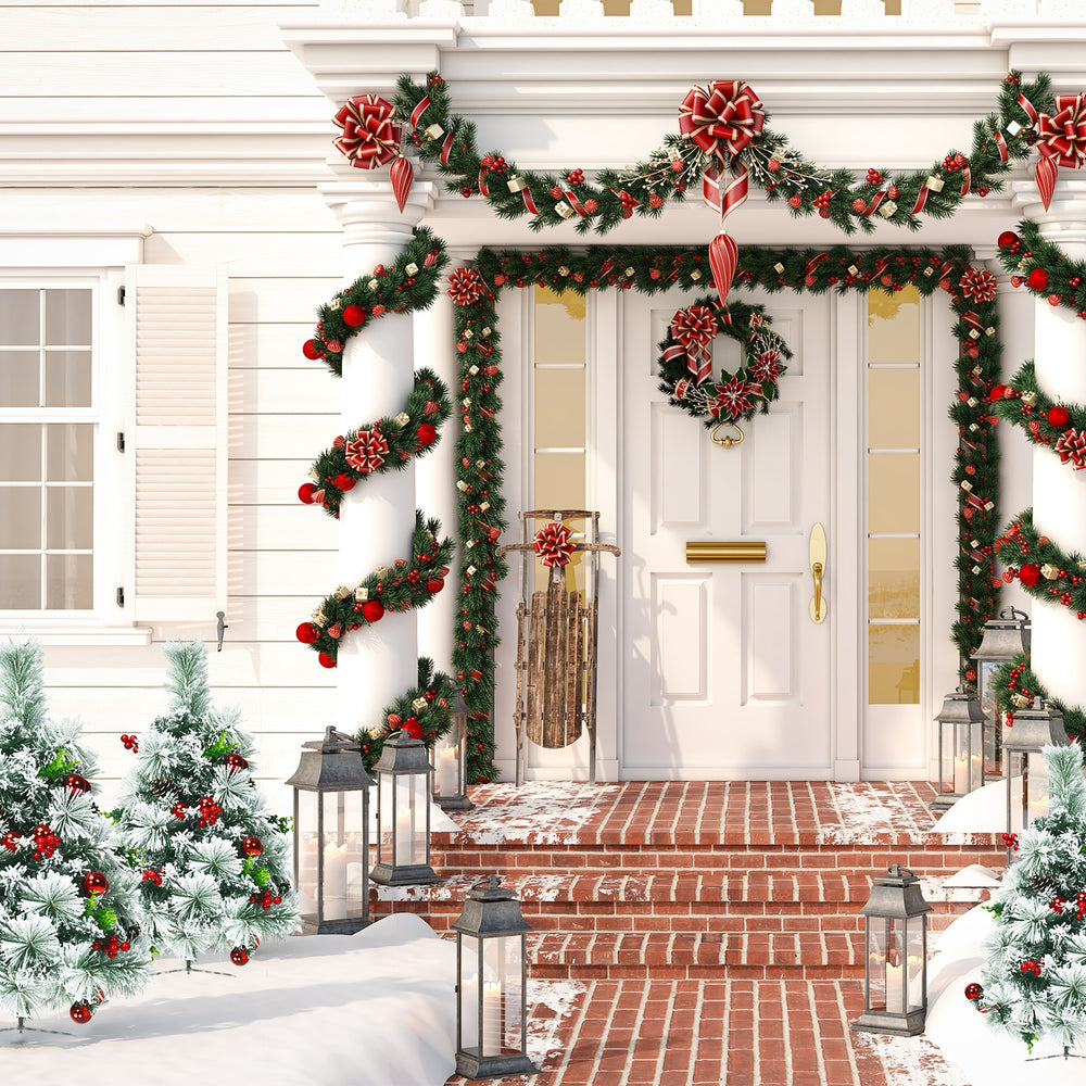 Flocked pre-lit Christmas tree set with red ornaments and warm LED lights, perfect for festive outdoor pathways.