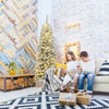 Snow flocked 6 feet pre-lit pencil Christmas tree with 250 LED lights, perfect for limited spaces and festive decor.