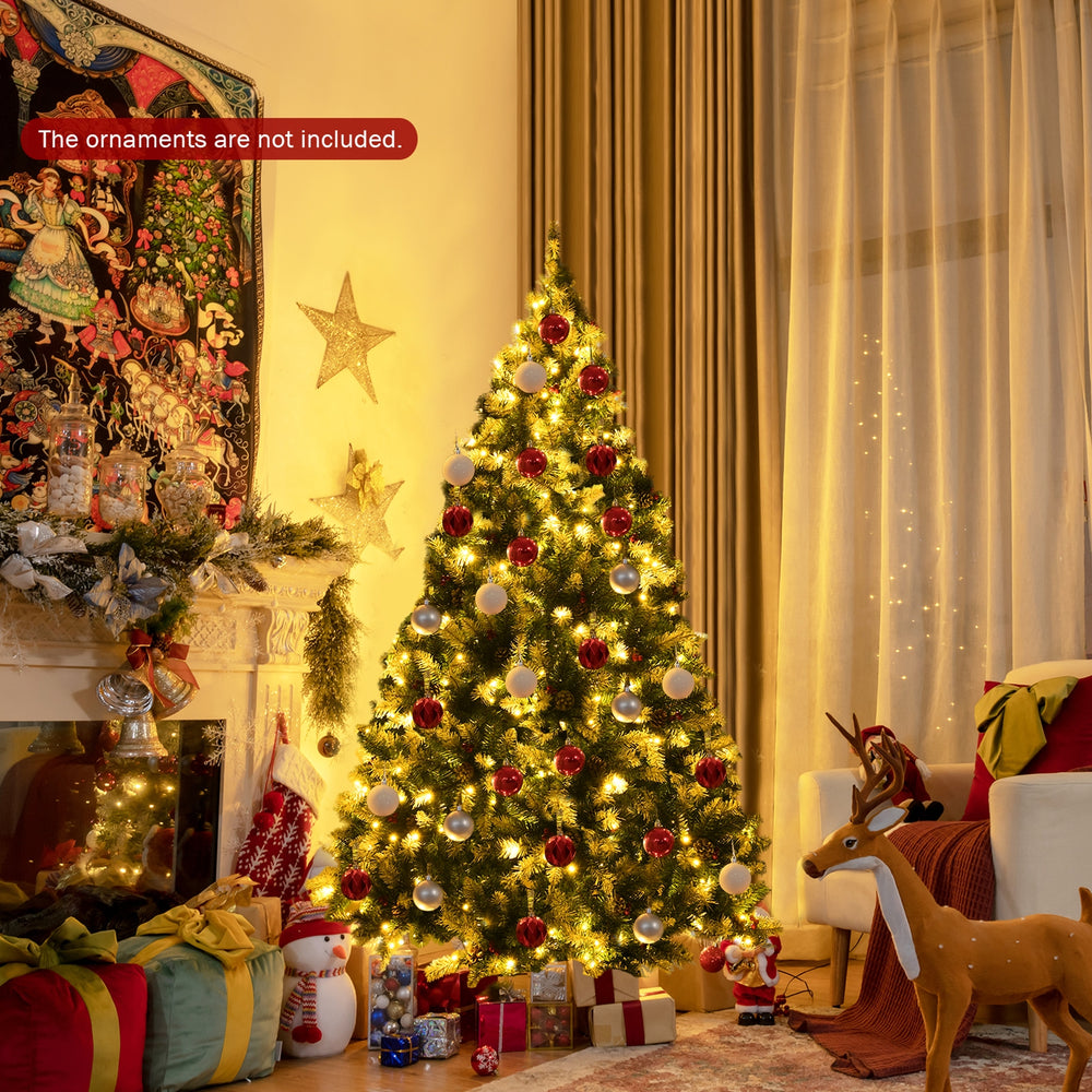 Snow flocked 6 ft Christmas tree with red berries and 250 warm white LED lights, perfect for festive home decoration.