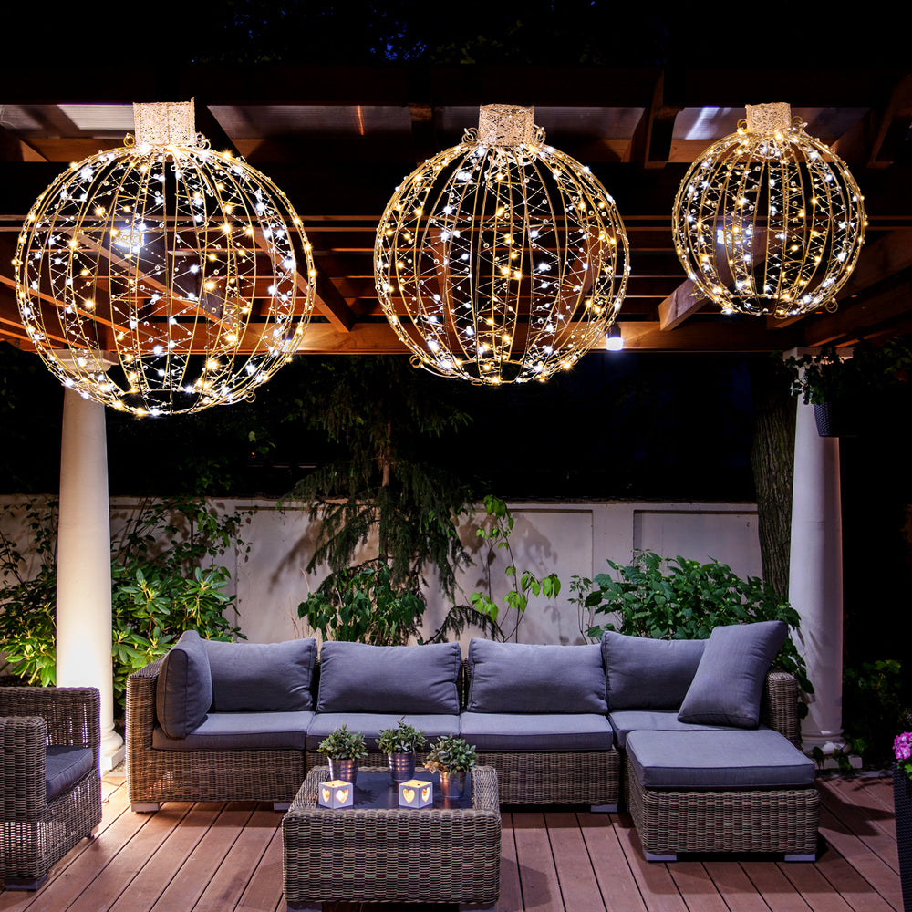 Three decorative LED light balls in golden hues, featuring warm and white lights, perfect for festive outdoor decor.
