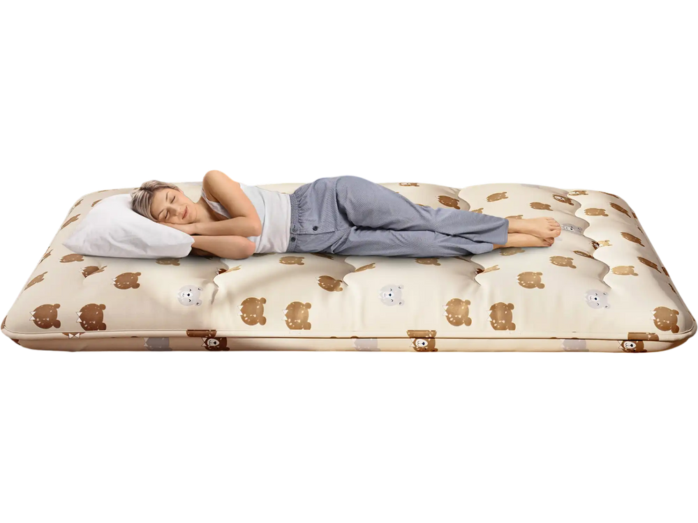 Foldable full-size futon mattress with washable cover, shown in a cozy bedroom setting, ideal for camping or home use.