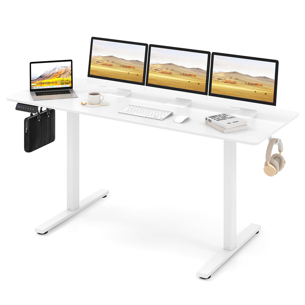 Electric standing desk in white with three monitors, adjustable height, and two hanging hooks for organized workspace.