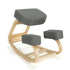 Ergonomic gray kneeling chair with curved wooden base, designed for upright posture and comfort, suitable for office.