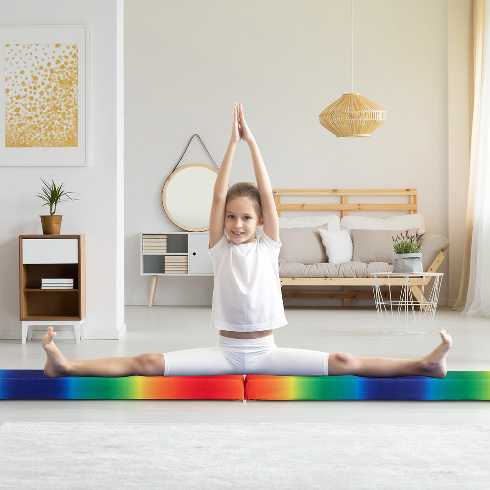 Child performing a split on a multicolor folding balance beam with solid wood base, ideal for home training or.