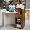 Front reception office desk in brown and white with an oval tabletop, open shelf, and lockable storage drawer.