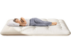 Beige full-size futon mattress sleeping pad with a washable cover, shown in a cozy bedroom setting.