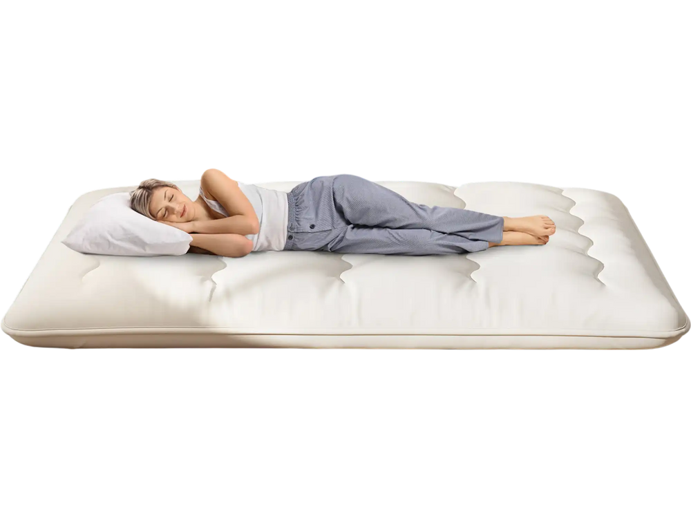 Beige full-size futon mattress sleeping pad with a washable cover, shown in a cozy bedroom setting.