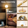 Glass globe LED floor lamp in gold with easy assembly instructions, perfect for home or office decoration.