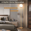 Glass globe LED floor lamp with brushed gold finish, featuring a milky-white glass lampshade for stylish home decor.