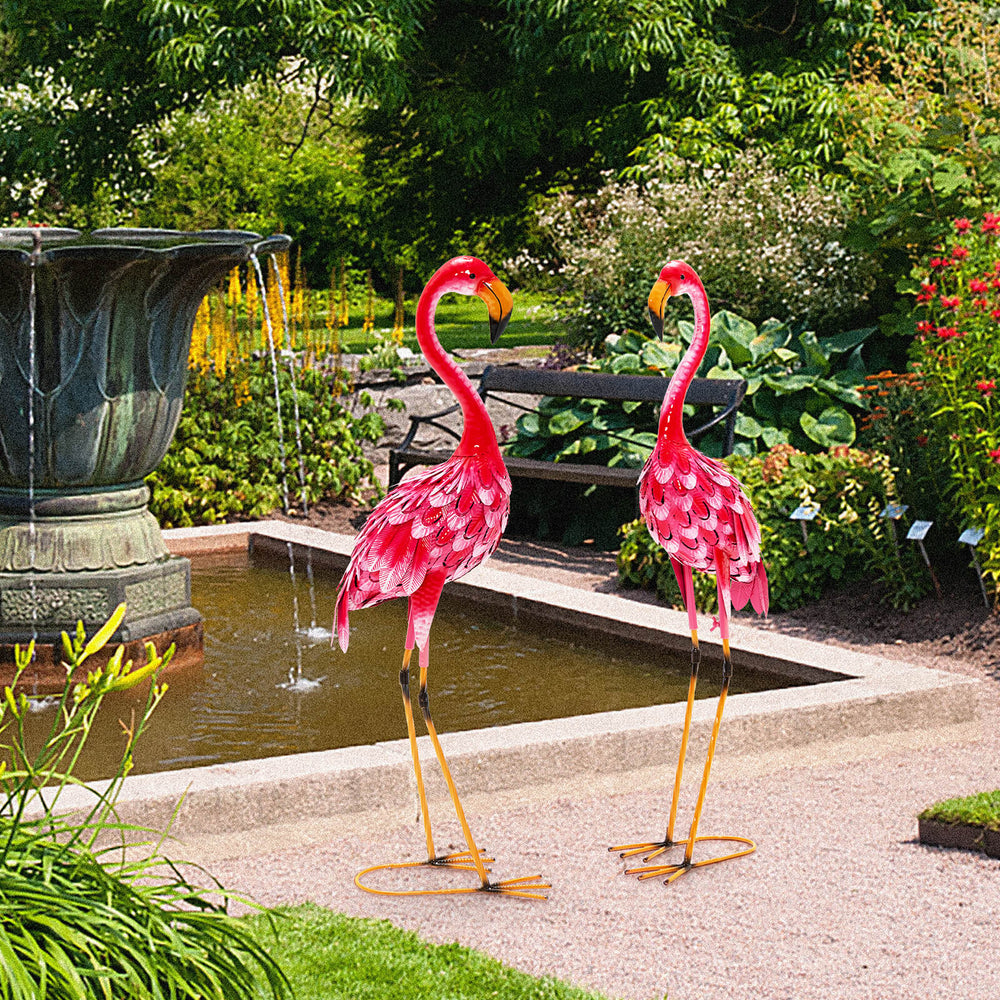 Two pink flamingo garden statues with U-shaped stakes, made of rustproof metal, adding charm to outdoor spaces.