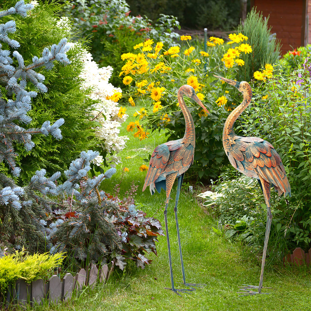 Set of 2 metal crane garden statues with U-shaped stakes, featuring delicate feathers for charming outdoor decoration.