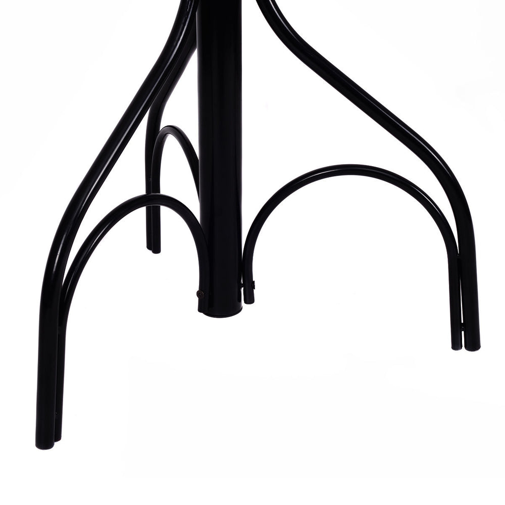 Close-up of the sturdy black metal base of a vintage coat hat tree stand with elegant design and six hooks.
